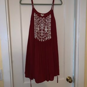red flowing dress with pattern on chest